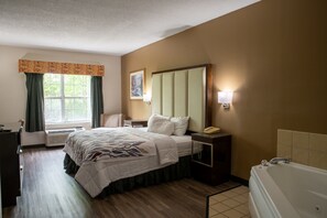 Chambre supérieure, 1 très grand lit, non-fumeur, baignoire à remous | Bureau, accès au Wi-Fi (inclus), literie fournie, réveille-matin