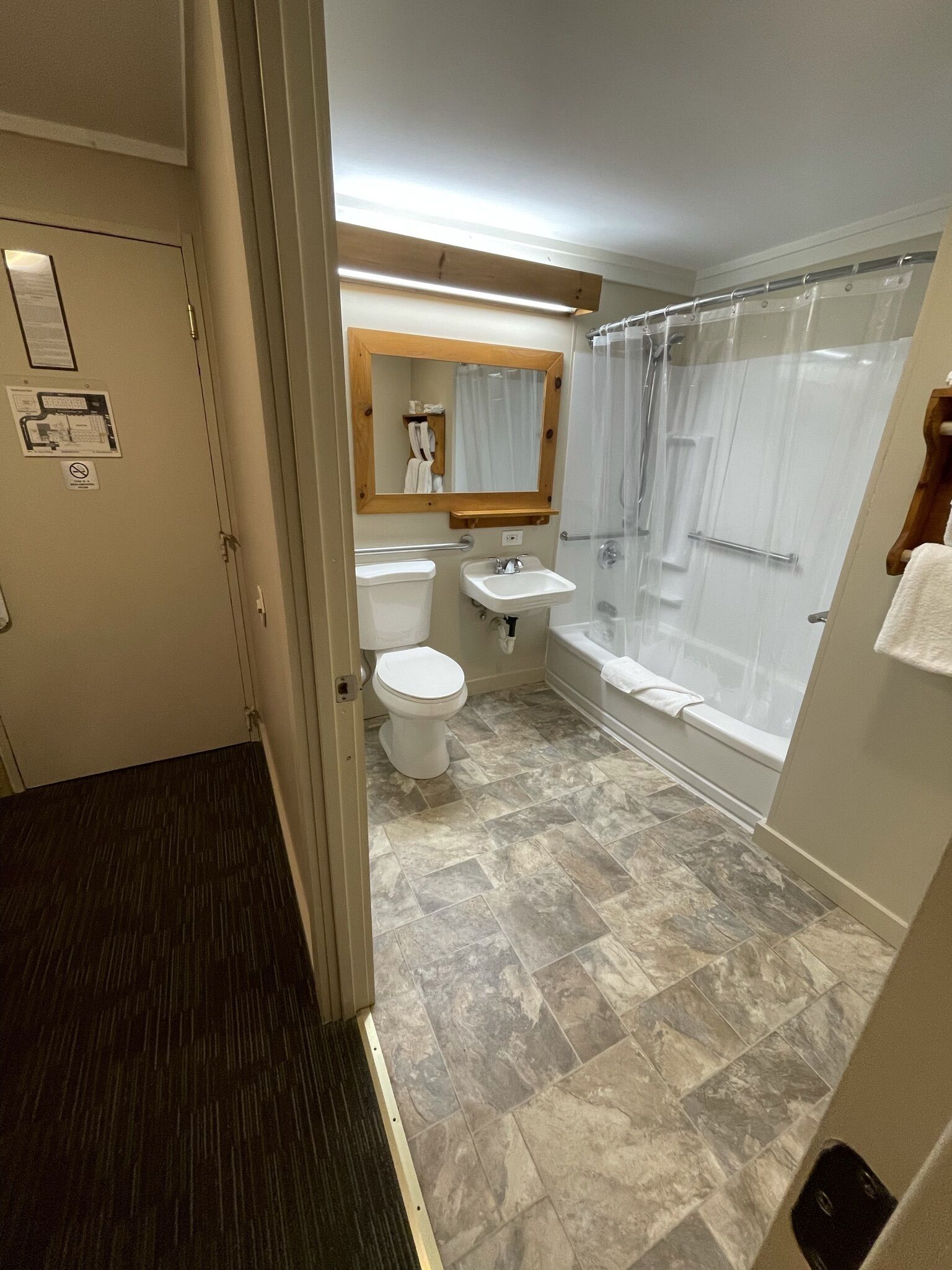 A bathroom with a toilet, sink, and shower.