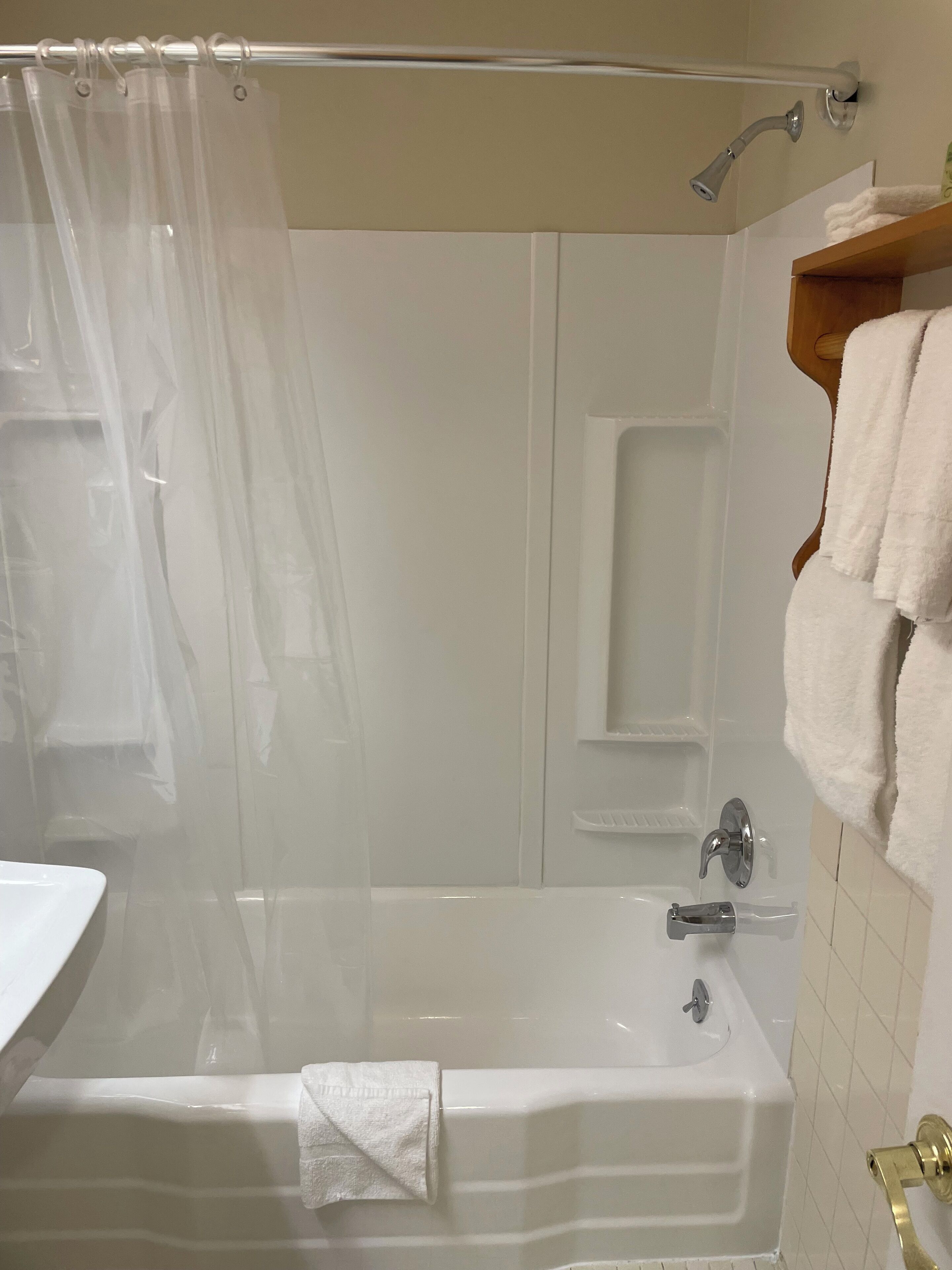 A bathroom with a bathtub, a shower, and a toilet.