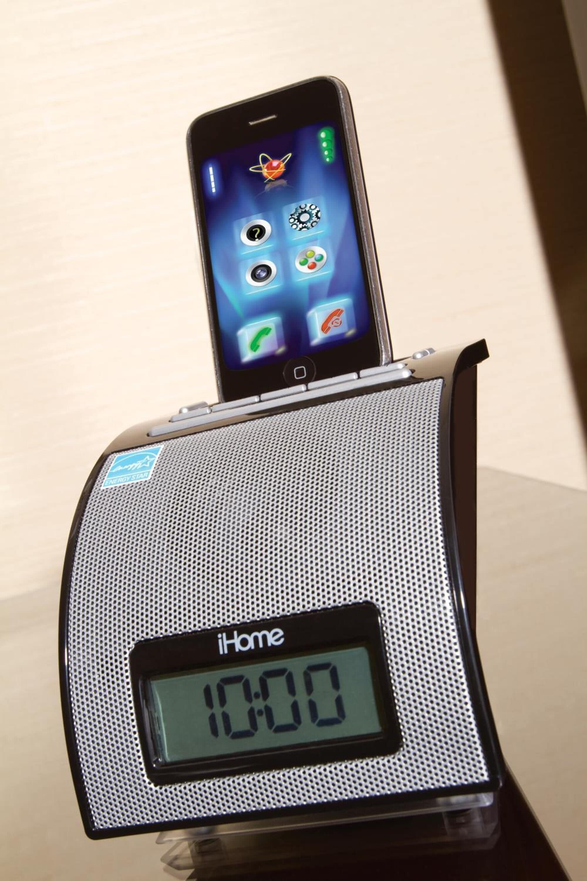 A digital clock with the display reading 10:00, placed on a table.