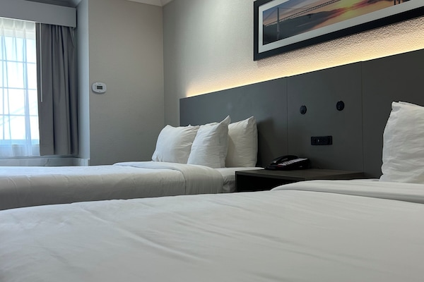 Standard Room, 2 Queen Beds, Non Smoking | In-room safe, desk, blackout drapes, iron/ironing board