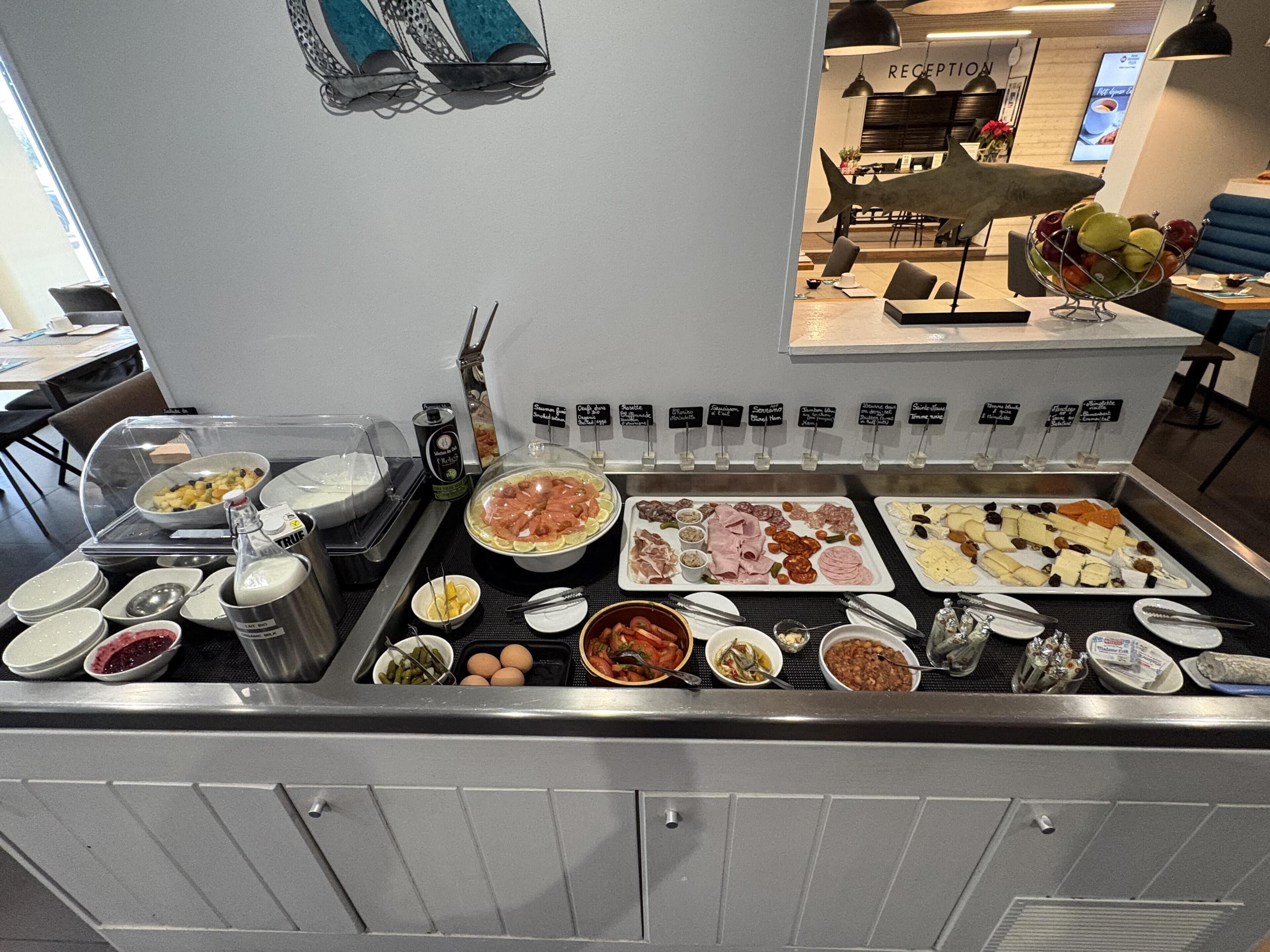 A buffet with various food items and condiments.
