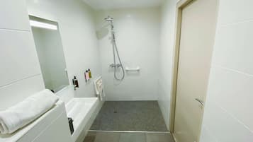 A modern bathroom with a shower, a sink, and a mirror.