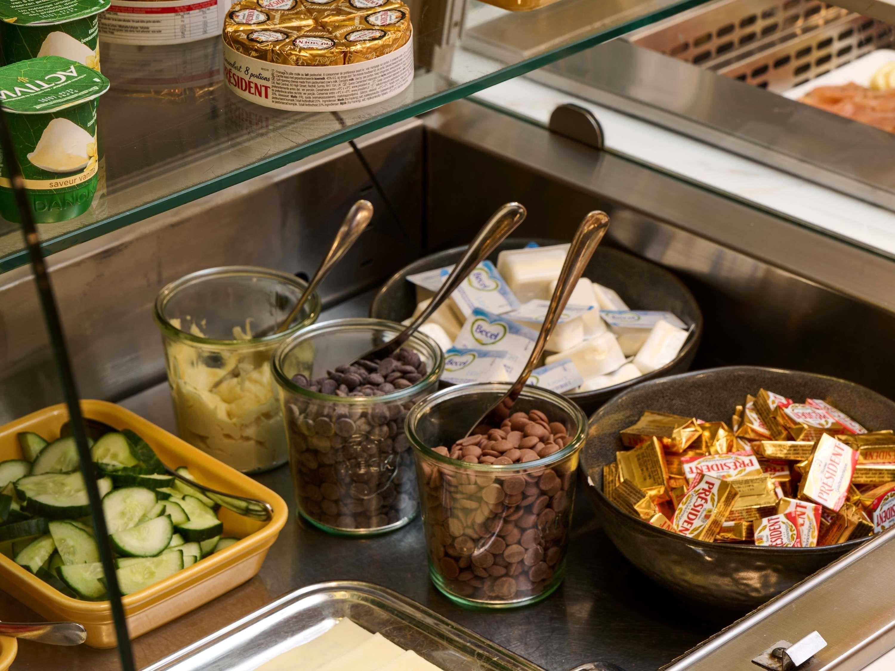 A food display with various items including yogurt, chocolate chips, and cheese.
