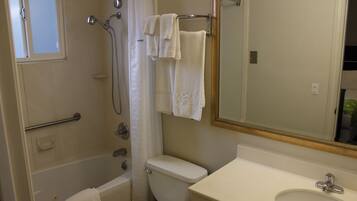 A bathroom with a bathtub, toilet, and sink.