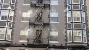 A multi-story building with a fire escape, a ground-floor entrance labeled "Hotel Jayne," and multiple windows. - Layne Hotel (San Francisco)