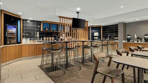 A modern cafe with bar stools, tables, and a counter with a beverage dispenser. - Springhill Suites By Marriott Minneapolis Eden Prairie (Eden Prairie)