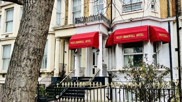 A building with two red awnings labeled "West Cromwell Hotel." - West Cromwell Hotel (London)