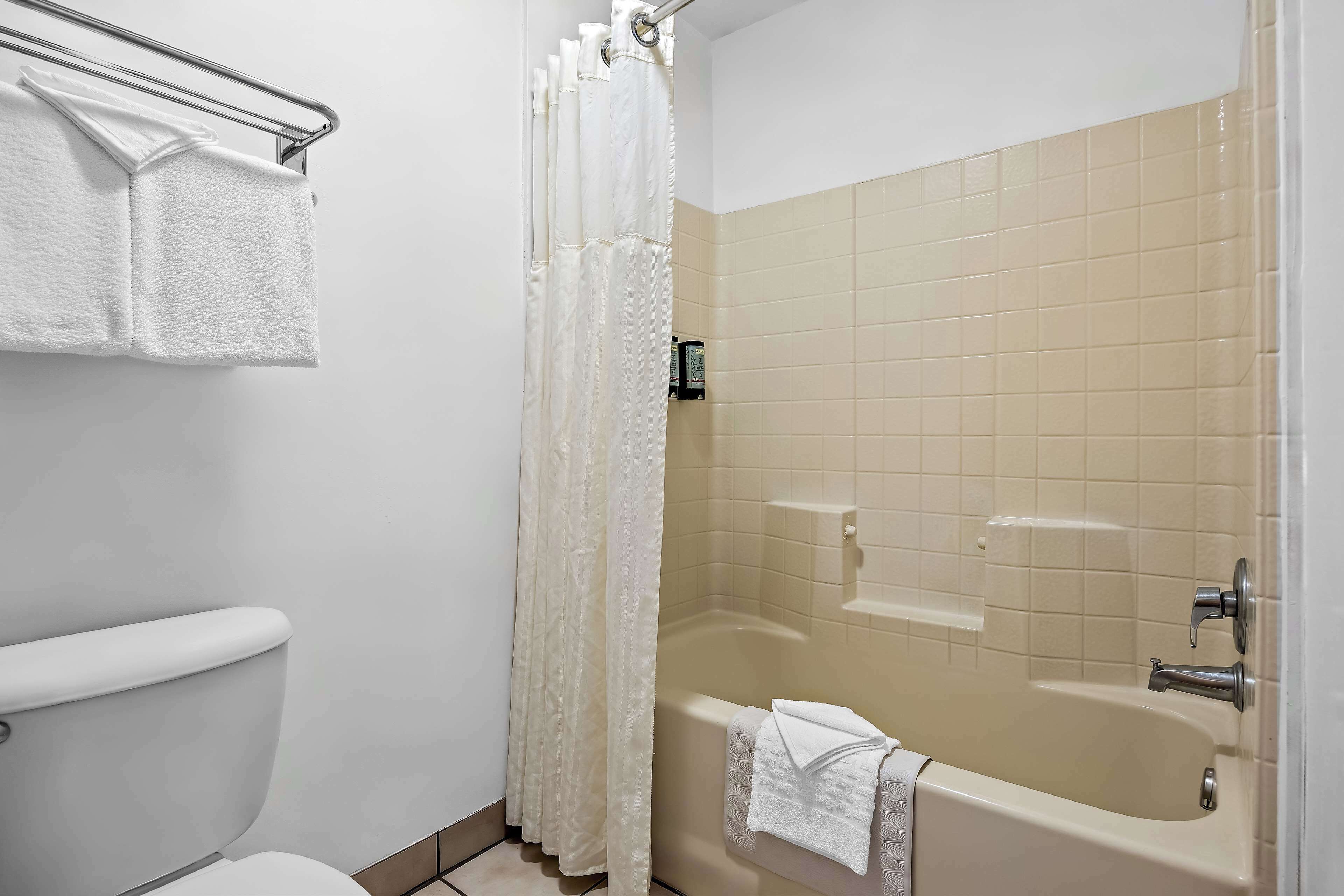 standard room, 2 queen beds, non smoking, refrigerator & microwave | bathroom | shower, free toiletries, hair dryer, towels