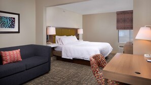 A hotel room with a bed, a sofa, a chair, and a desk. - Hampton Inn Phoenix/Anthem (Phoenix)