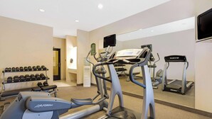 A gym with treadmills, elliptical machines, and dumbbells. - Baymont by Wyndham Tucson Airport (Tucson)
