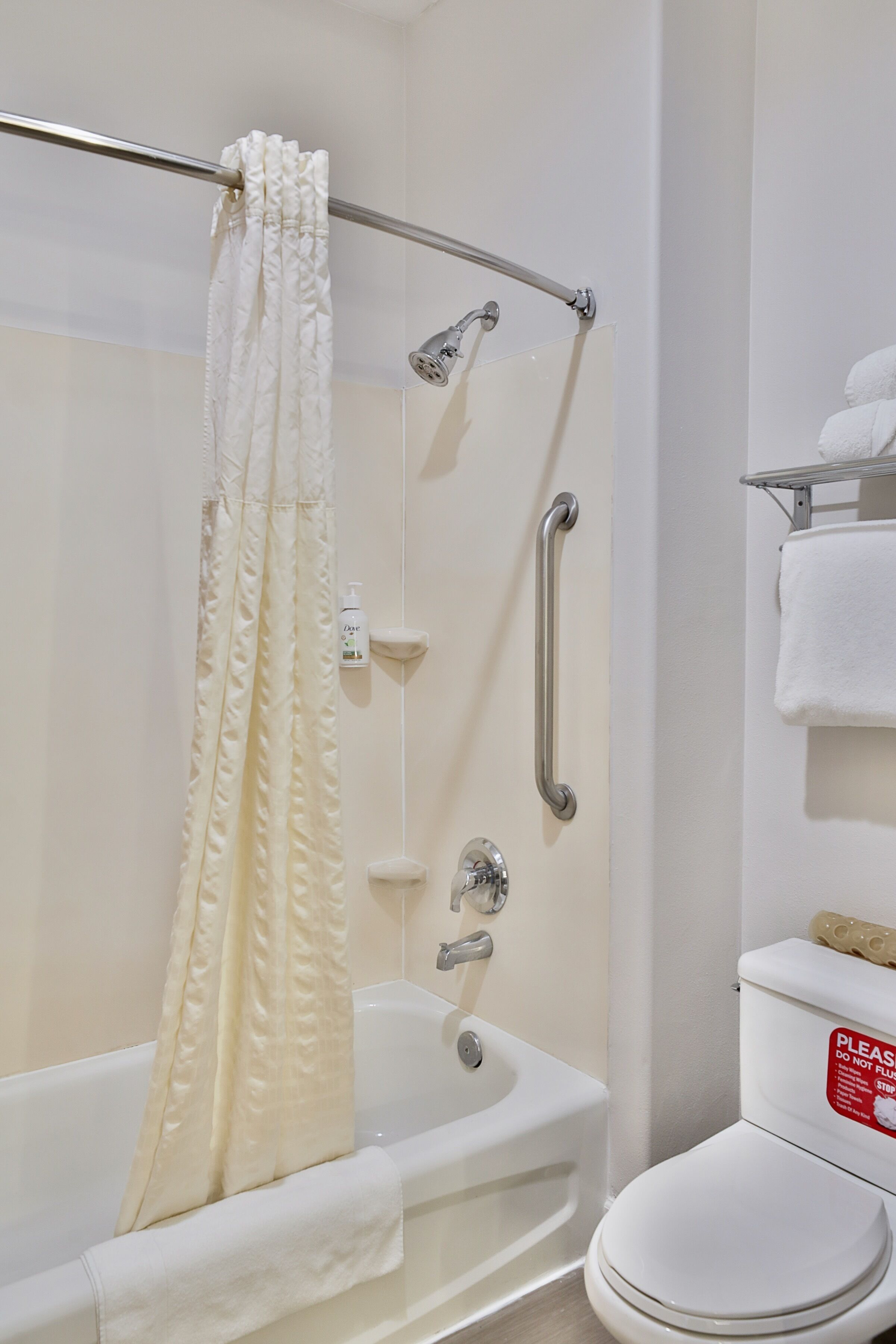 A bathroom with a bathtub, shower, and toilet.
