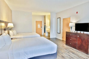 A hotel room with two beds, a TV, a dresser, and a bathroom visible in the background. - Comfort Inn & Suites - Tucson Airport (Tucson)