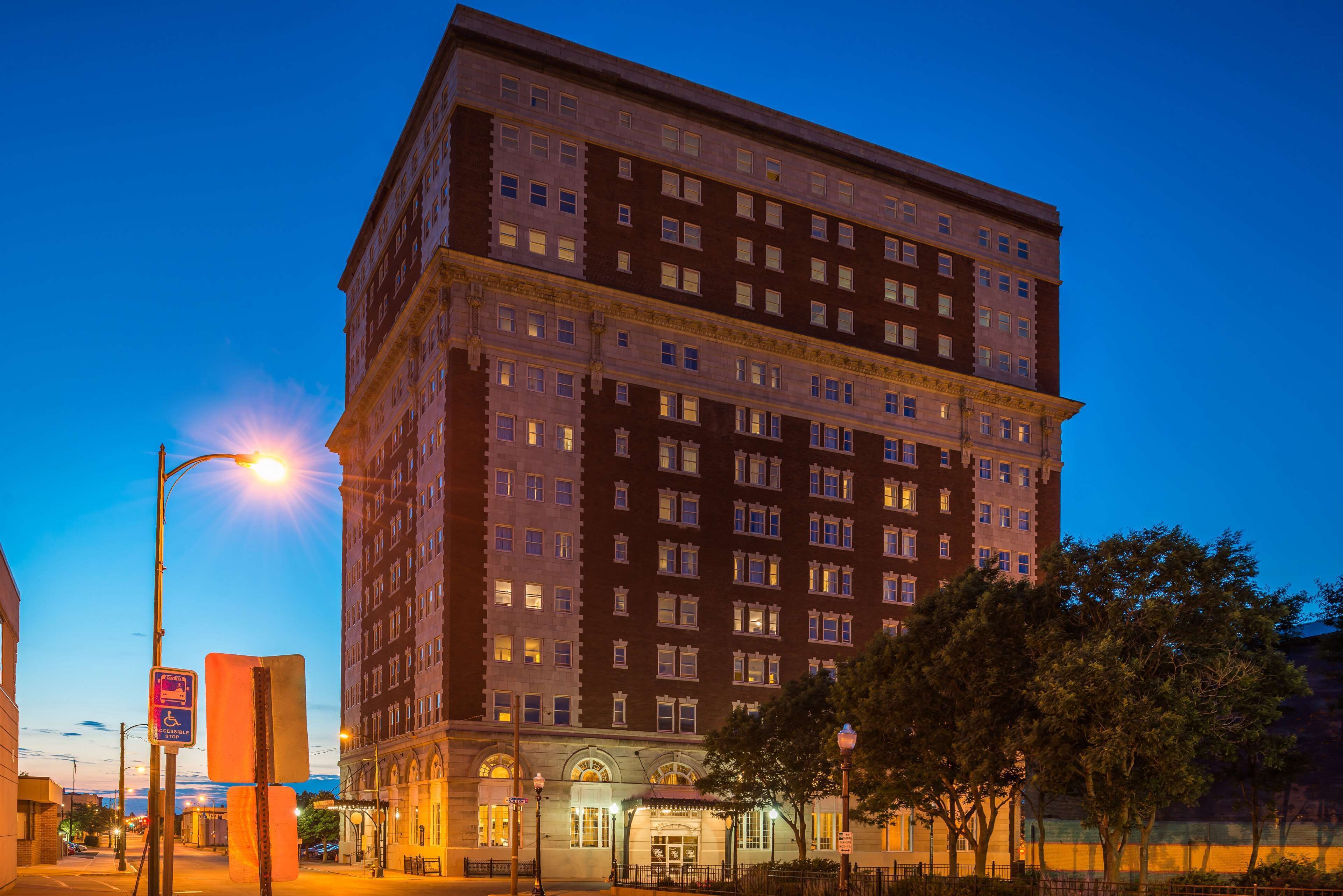 A multi-story hotel with a classic architectural design, featuring a central entrance and multiple windows on each floor.