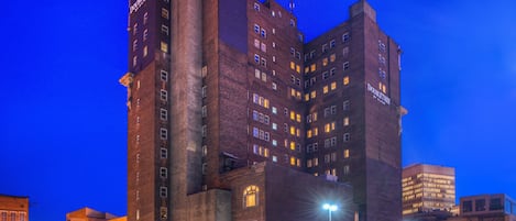 A multi-story hotel with a prominent 'DoubleTree' sign, featuring a classic architectural design with brickwork and multiple windows.