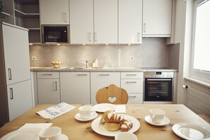 Comfort Apartment, 1 Bedroom | Private kitchen | Full-sized fridge, stovetop, coffee/tea maker, electric kettle
