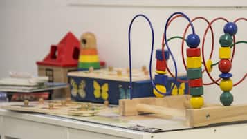 A children's play area with toys and educational materials.