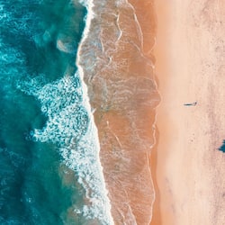On the beach, surfing