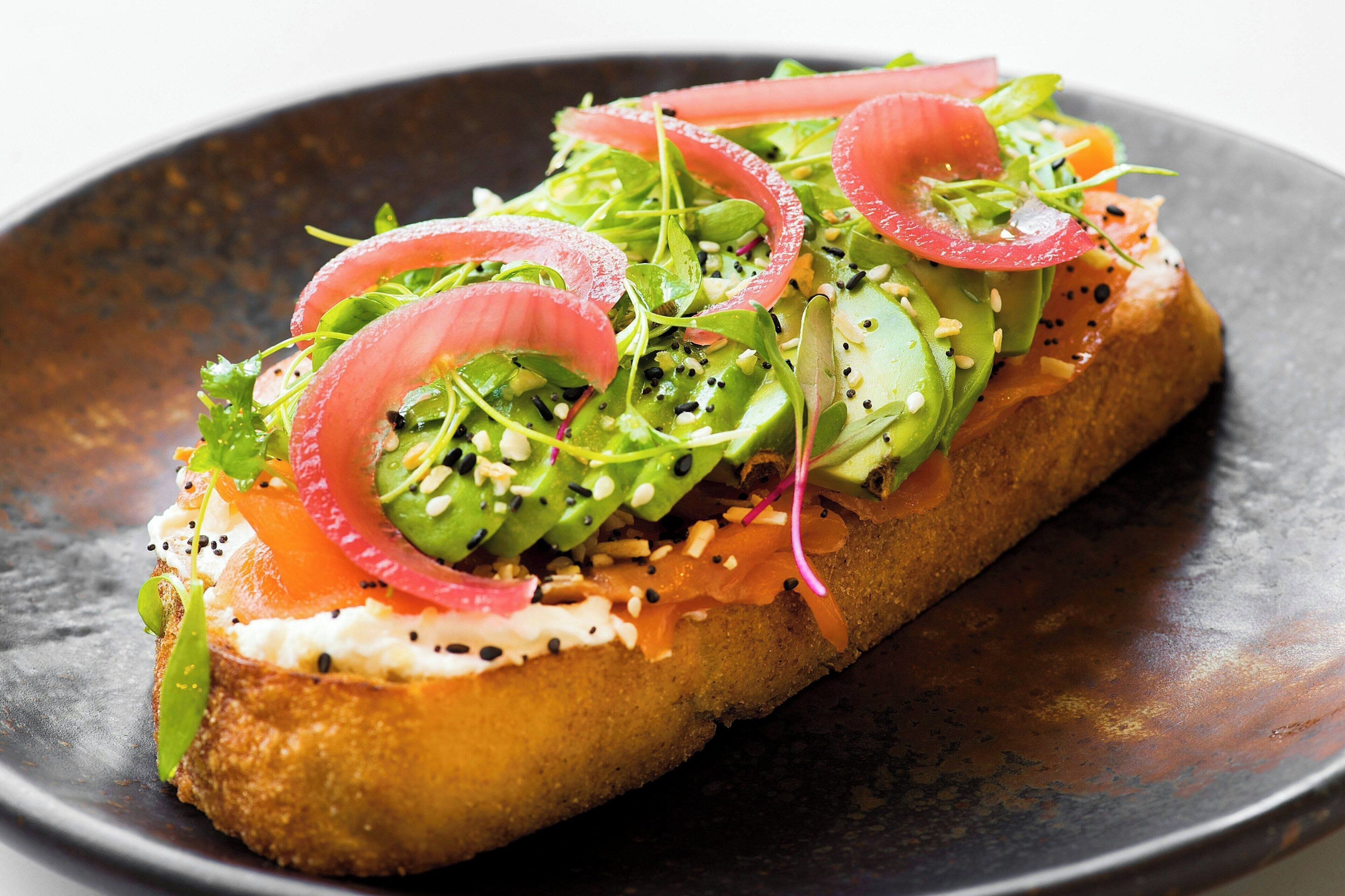 A sandwich with various toppings on a plate.