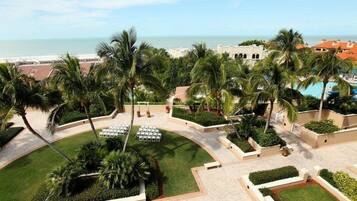 Relax by the pool surrounded by palm trees and enjoy stunning ocean views.