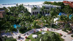 A resort with a pool, palm trees, and a beach view. - Marco Beach Ocean Resort (Marco Island)