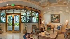 A lobby with a grand entrance, a sofa set, and a painting on the wall. - Marco Beach Ocean Resort (Marco Island)