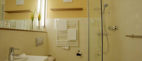 A bathroom with a sink, toilet, and shower.