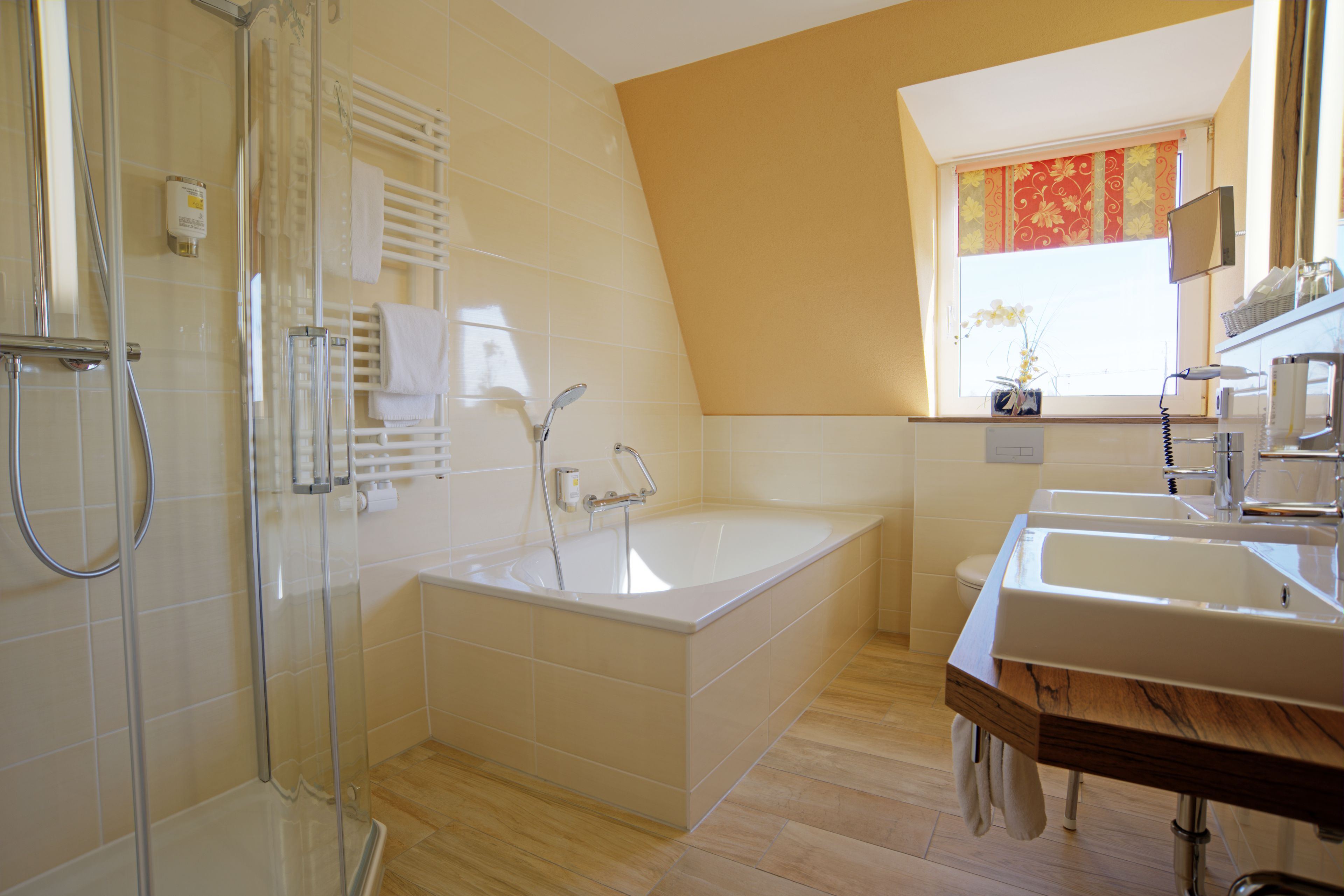 Une salle de bain moderne dotée d’une douche à parois de verre, d’une baignoire sur pieds et d’un meuble-lavabo.