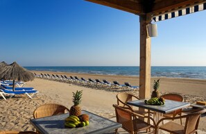 Plage, sable blanc, chaises longues, parasols