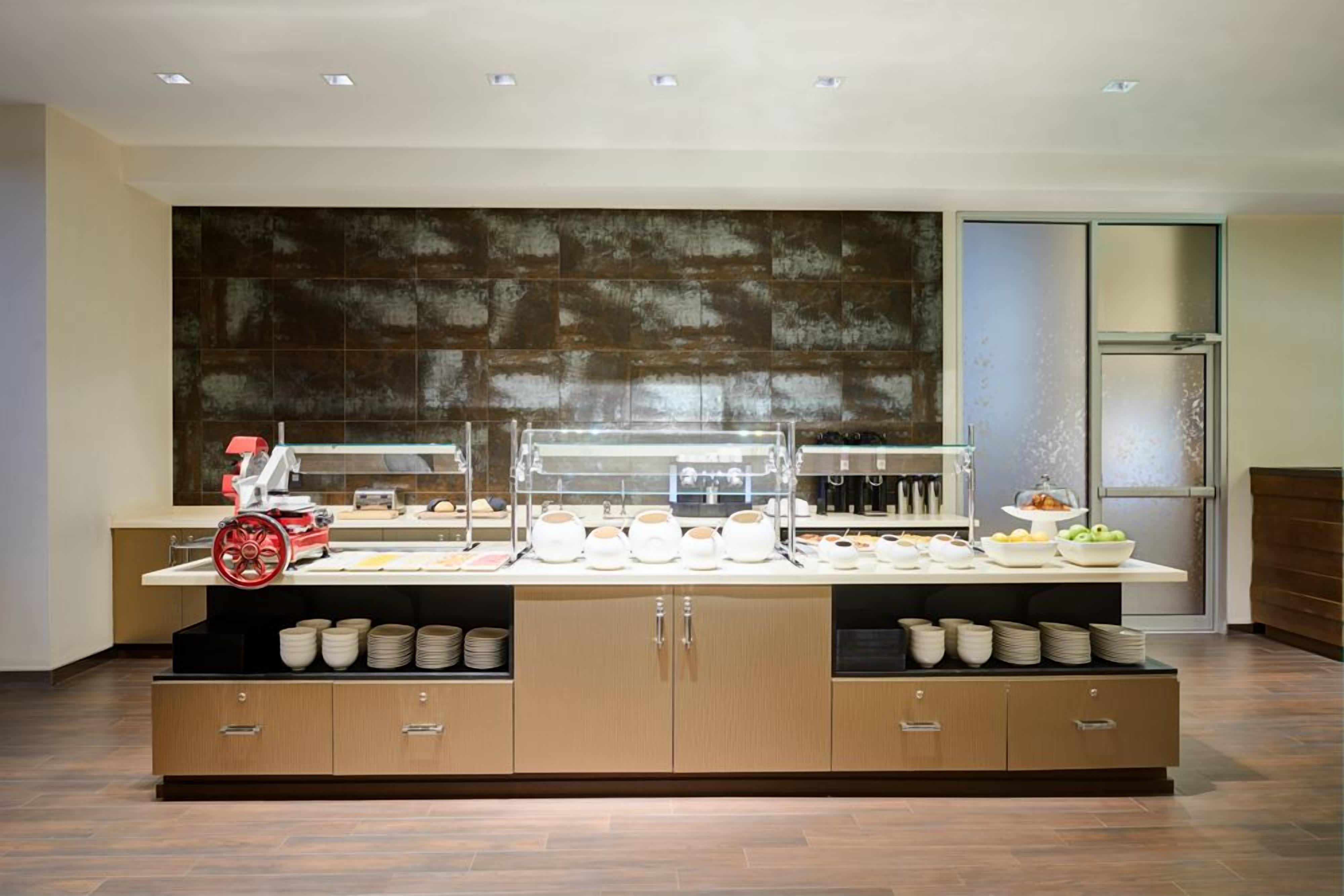 A buffet setup with a variety of dishes and a coffee station.