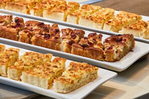 A tray of baked goods, likely a type of bread or pastry, arranged on a white plate. - AC Hotel by Marriott New Orleans French Quarter (New Orleans)