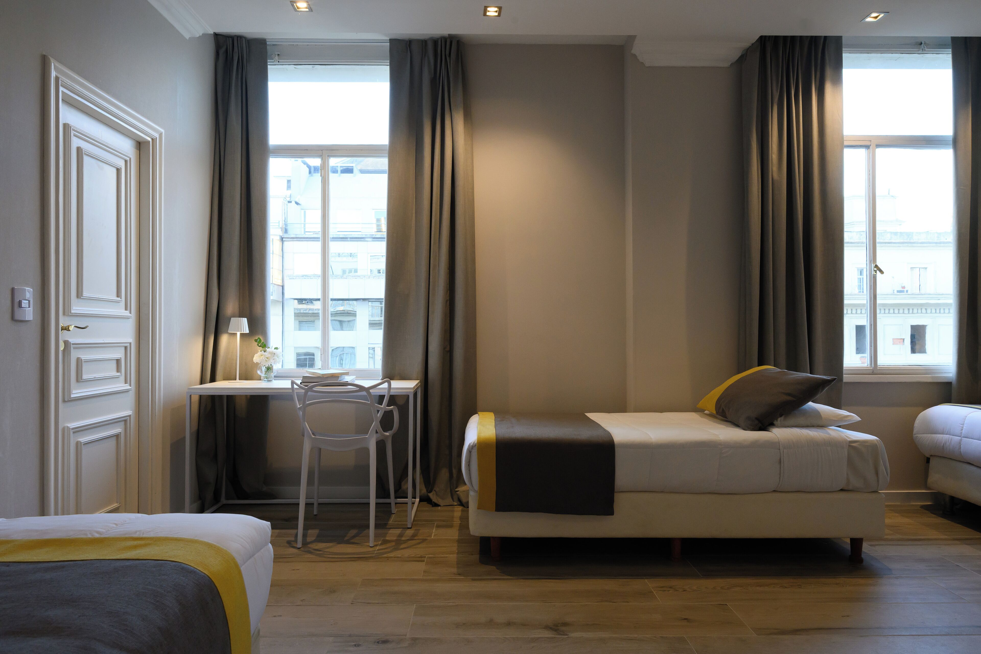 Una habitación de hotel con cama, escritorio y silla.