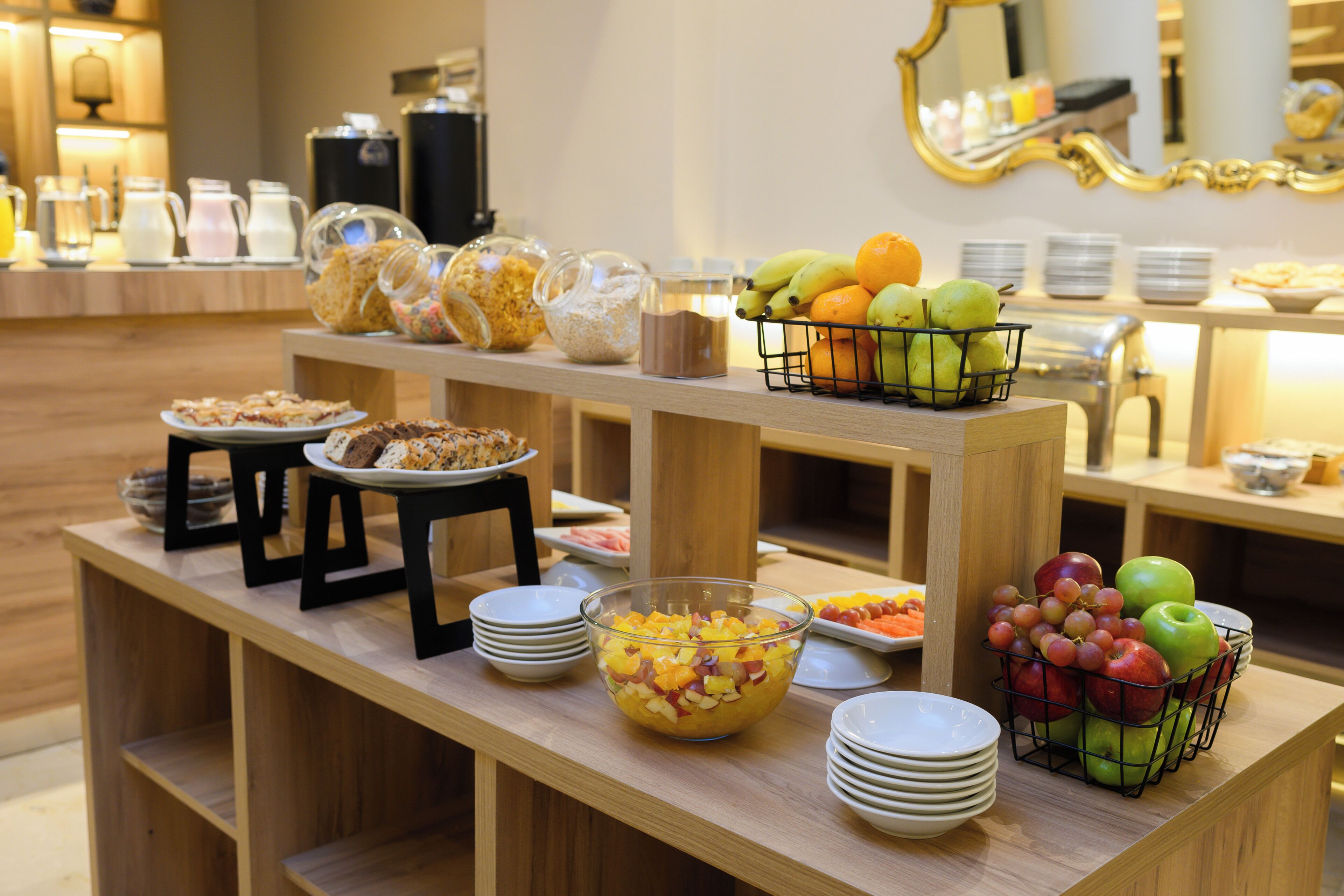 A buffet setup with various food items and beverages.