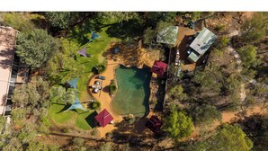 An aerial view of a campsite with a swimming pool, picnic tables, and tents. - Discovery Resorts - Kings Canyon (Petermann)