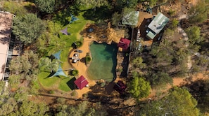 An aerial view of a campsite with a swimming pool, picnic tables, and tents. - Discovery Resorts - Kings Canyon (Petermann)