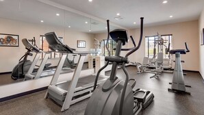 A modern gym with treadmills, elliptical machines, and weight equipment. - Best Western Plus Gateway Inn & Suites (Aurora)