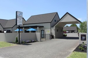 Um edifício moderno com uma placa indicando Bethlehem Motor Inn, mostrando que é um local para eventos e conferências.