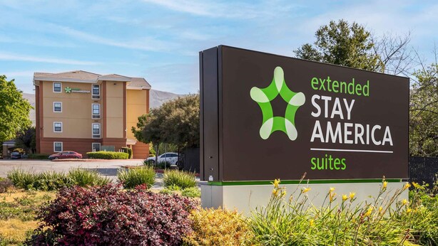 A Stay America sign with a building in the background. - Extended Stay America Suites Fremont Warm Springs (Fremont)