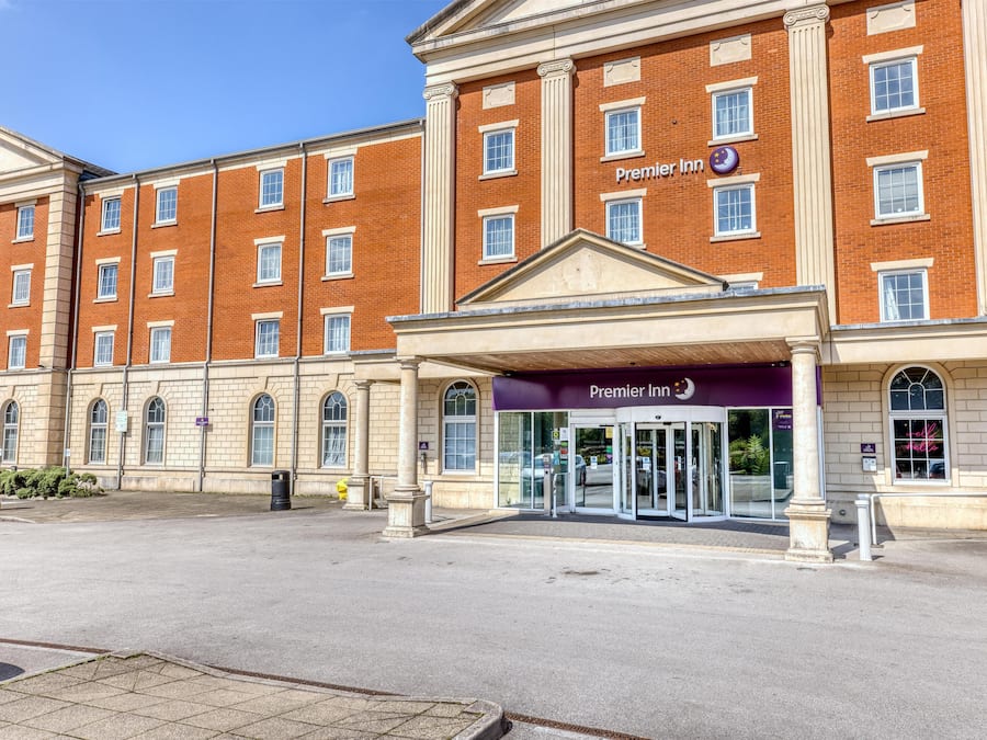 A brick building with a sign reading 'Premier Inn.'