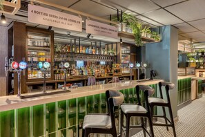 A bar area with multiple beer taps, shelves with bottles, and a daily lunch deal sign. - Premier Inn Manchester Trafford Centre Wst (Manchester)