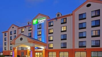 A multi-story Holiday Inn Express building with a prominent entrance and signage.