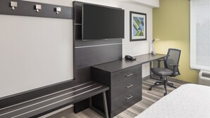 A hotel room with a bed, a desk with a chair, a flat-screen TV, and a bench. - Holiday Inn Express & Suites Greenville-I-85 & Woodruff Rd by IHG (Greenville)