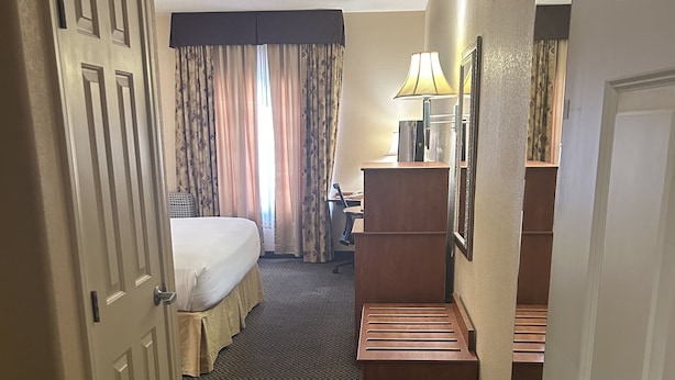 A hotel room with a bed, desk, and a small seating area. - Holiday Inn Express Las Vegas-Nellis by IHG (Las Vegas)