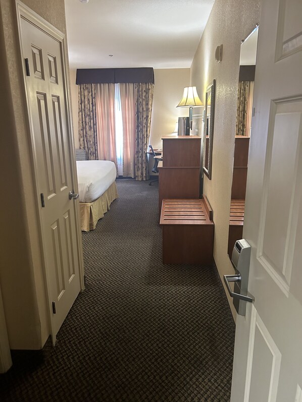 A hotel room with a bed, desk, and a small seating area. - Holiday Inn Express Las Vegas-Nellis by IHG (Las Vegas)