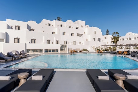 Seasonal outdoor pool, pool loungers. Santorini Palace