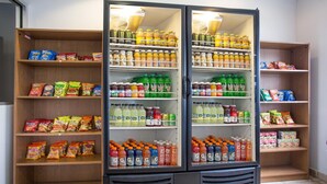 A refrigerated display case stocked with various beverages and snacks. - Stay Express Inn & Suites Atlanta (Union City)