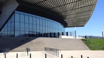 A modern building with a curved roof and large glass windows.
