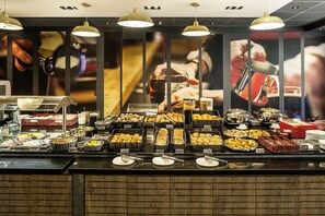 A buffet with various food items and beverages, including fruits, pastries, and drinks. - ibis Manchester Centre Princess Street (Manchester)