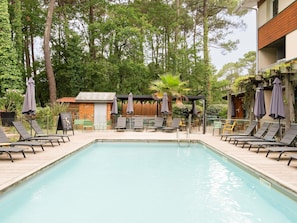 Seasonal outdoor pool, open 9:00 AM to 9:00 PM, pool umbrellas