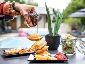 A breakfast setting with pancakes, toast, and fresh fruit. - ibis Arcachon La Teste (La Teste-de-Buch)